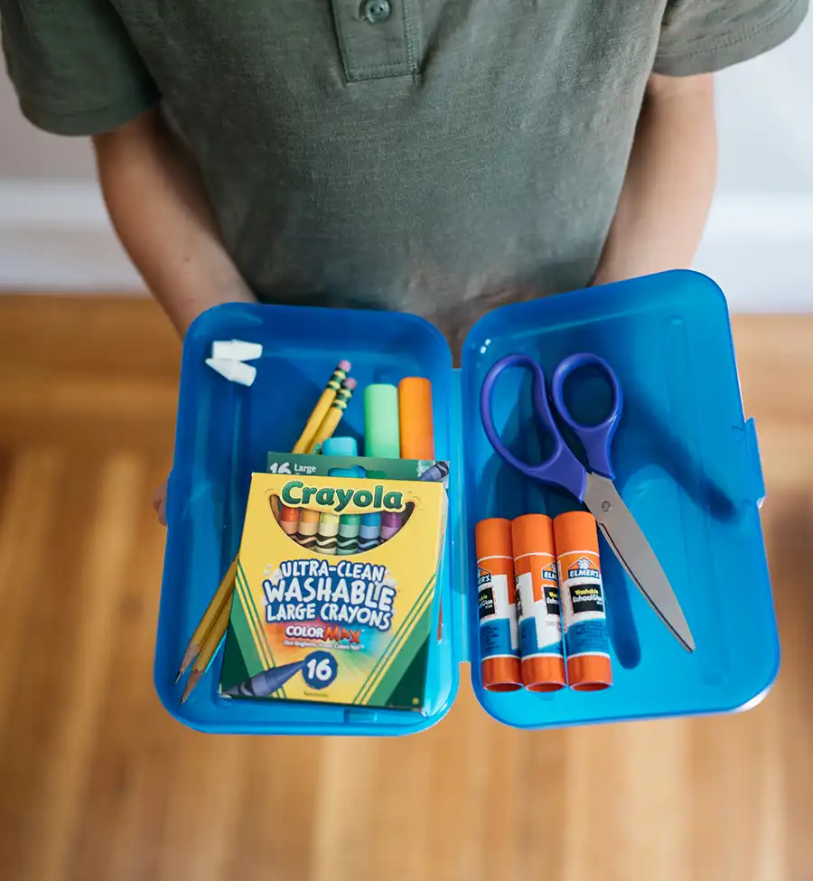 Child showing school supplies